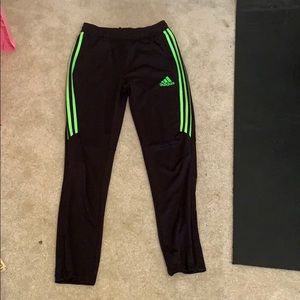 Adidas joggers with neon green lines on the side